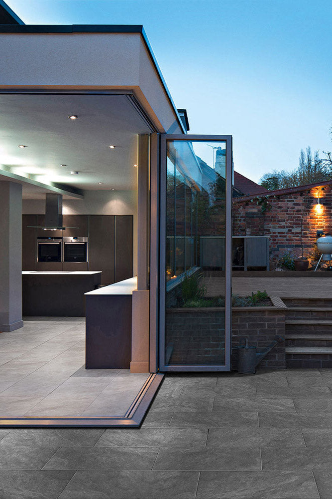CeramicLine³-Terrassenplatten in grauer Natursteinoptik von Woehe & Heydemann verlegt auf einer modernen Terrasse