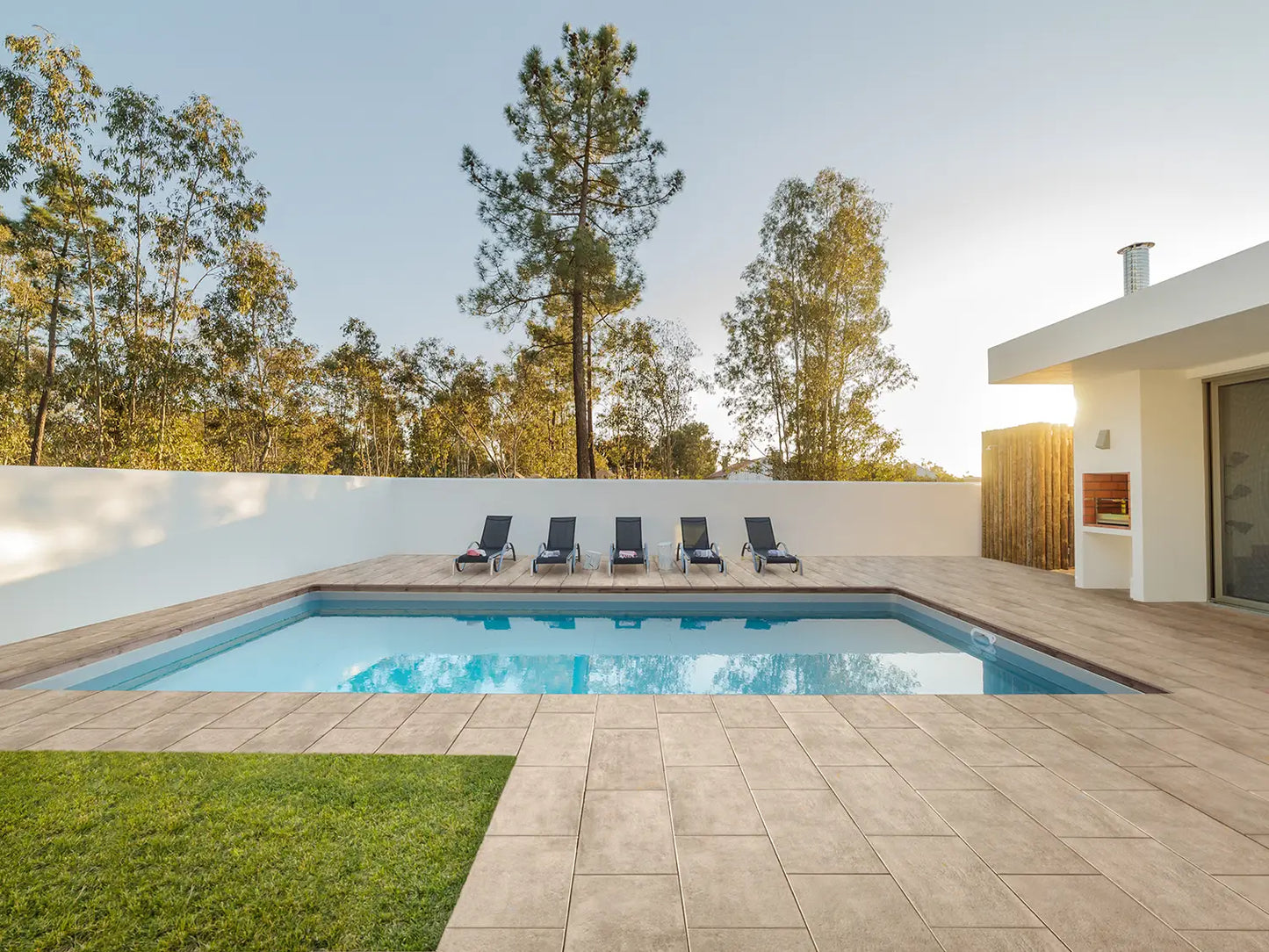 80x40 CreativeLine-Terrassenplatten in beiger Natursteinoptik von Woehe & Heydemann verlegt auf einer modernen Terrasse mit Pool