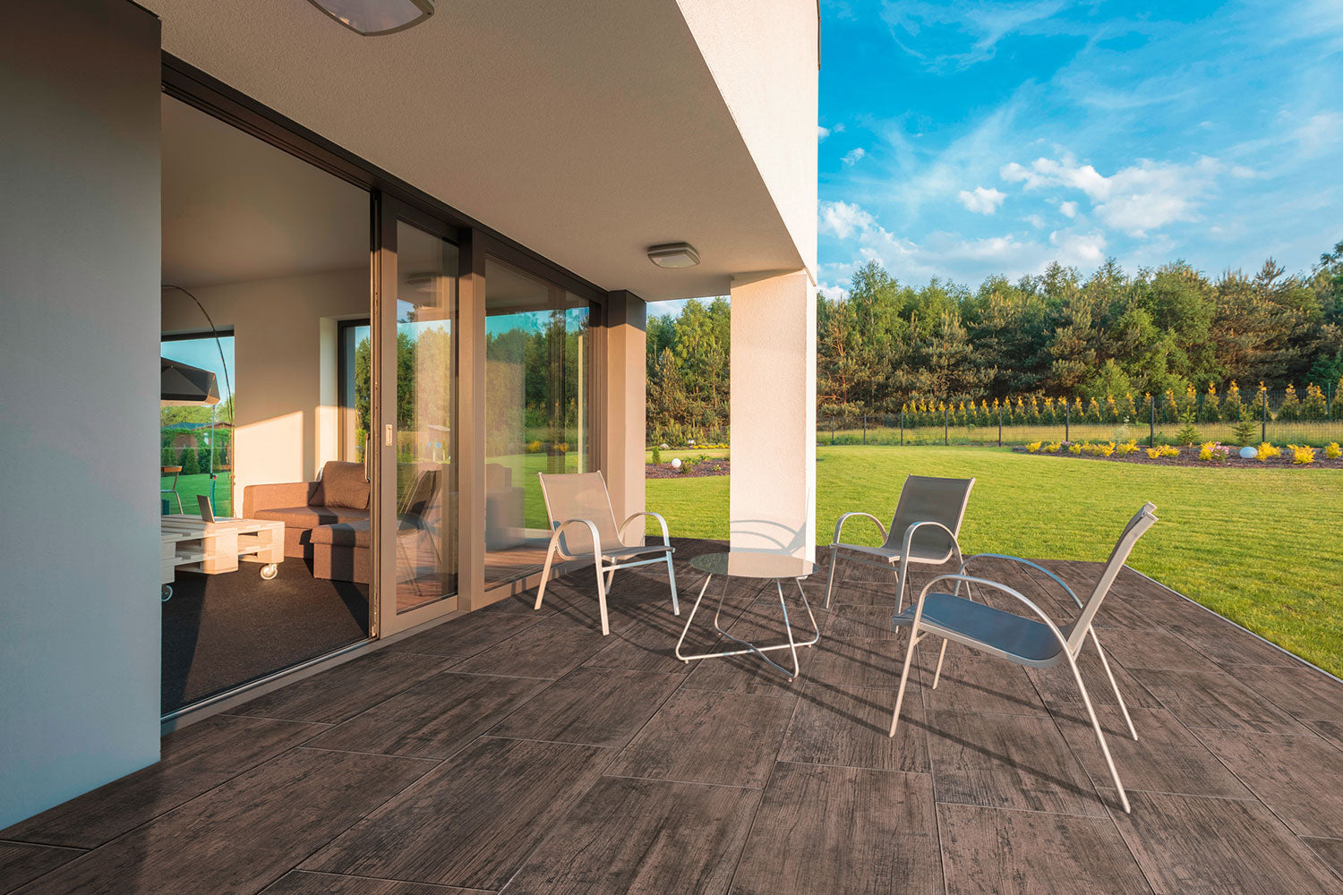 80x40 CreativeLine-Terrassenplatten in brauner Natursteinoptik von Woehe & Heydemann verlegt auf einer modernen Terrasse mit Blick in Garten